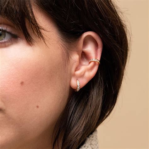 Handcrafted in 14k solid gold and set with rhodolite, green tourmaline. . Mejuri ear piercing